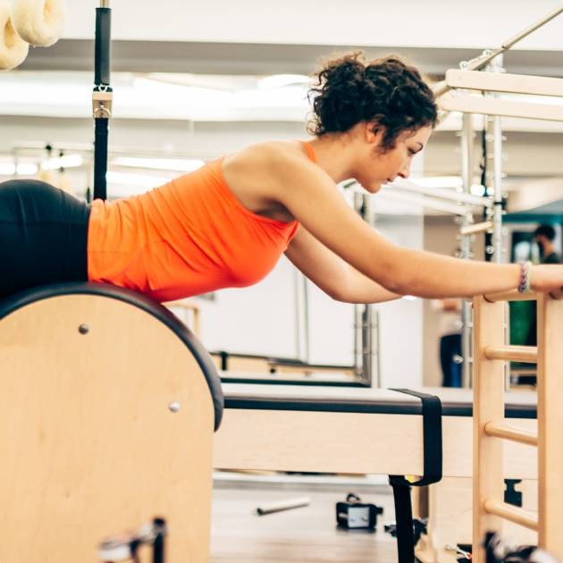 woman stretching on Ladder Barrel