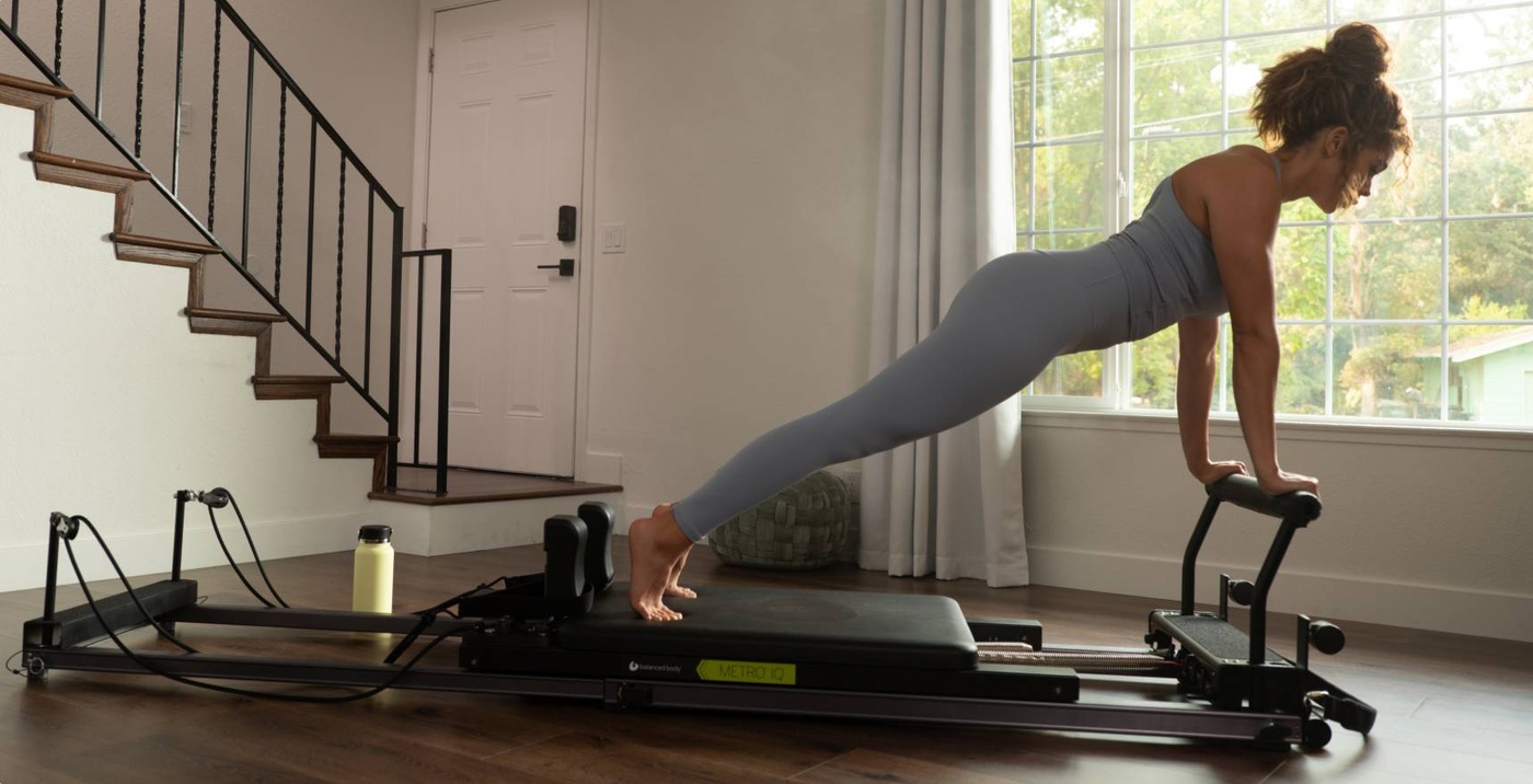 Woman using Metro IQ Reformer in home
