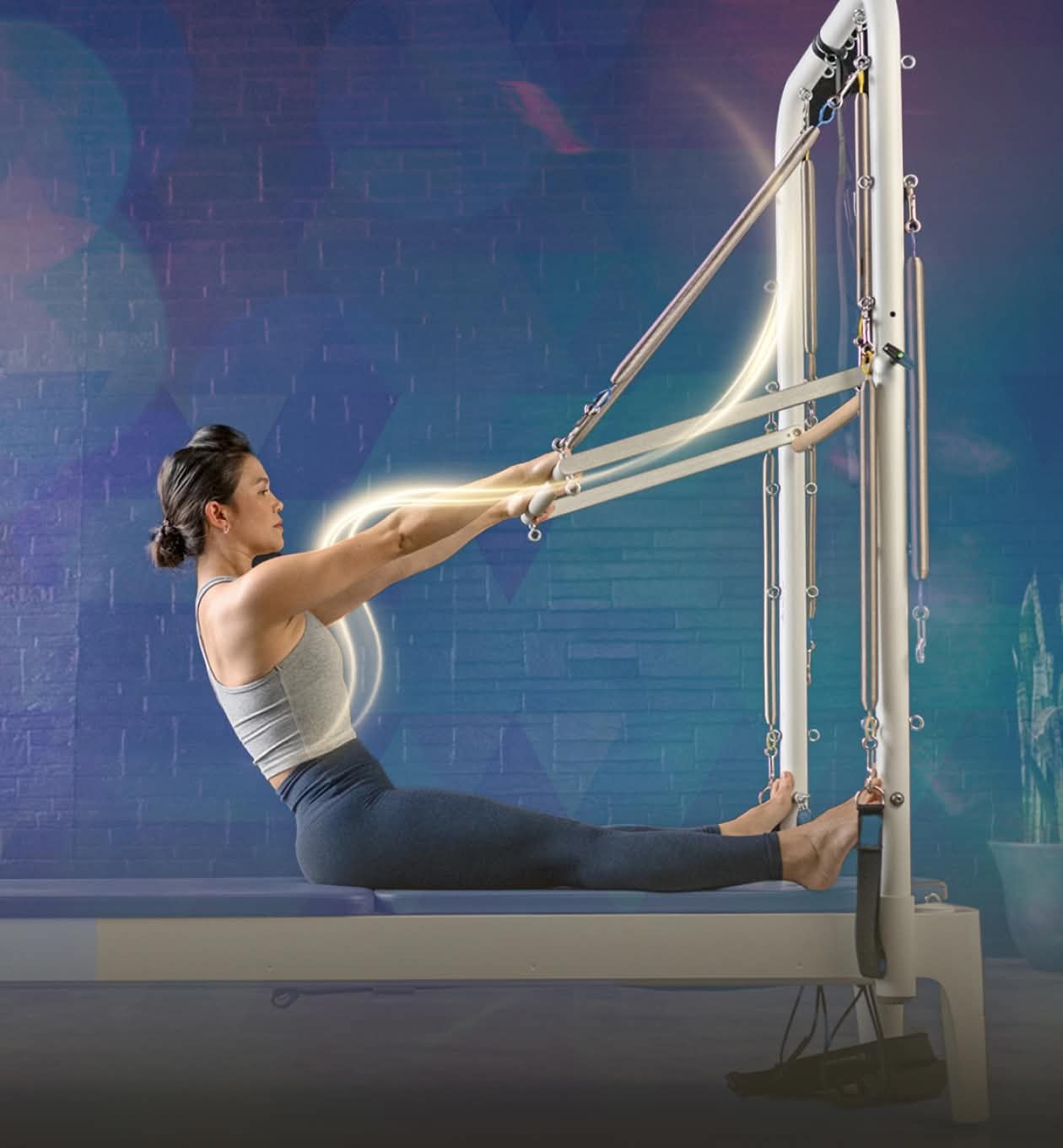 woman using reformer tower