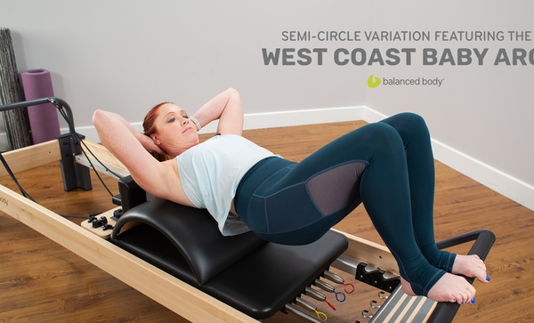 semi-circle variation featuring the west coast baby arc woman exercising on rialto reformer