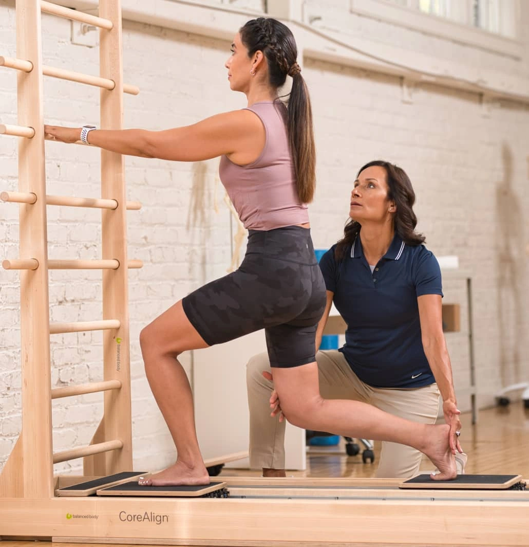 physical therapist helping patient with knee pain using a balanced body corealign