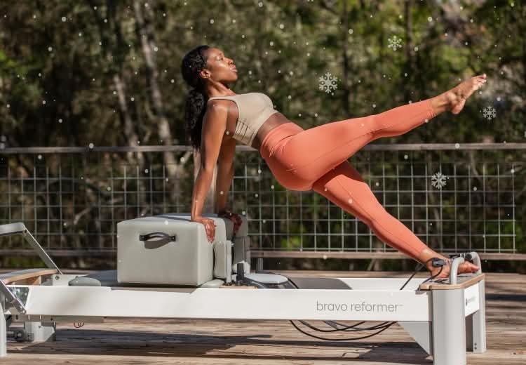 Woman on a Reformer using a Sitting Box