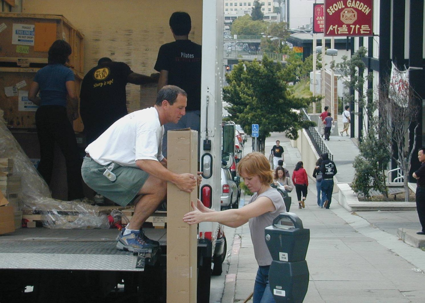 Unpacking a moving truck on a city street