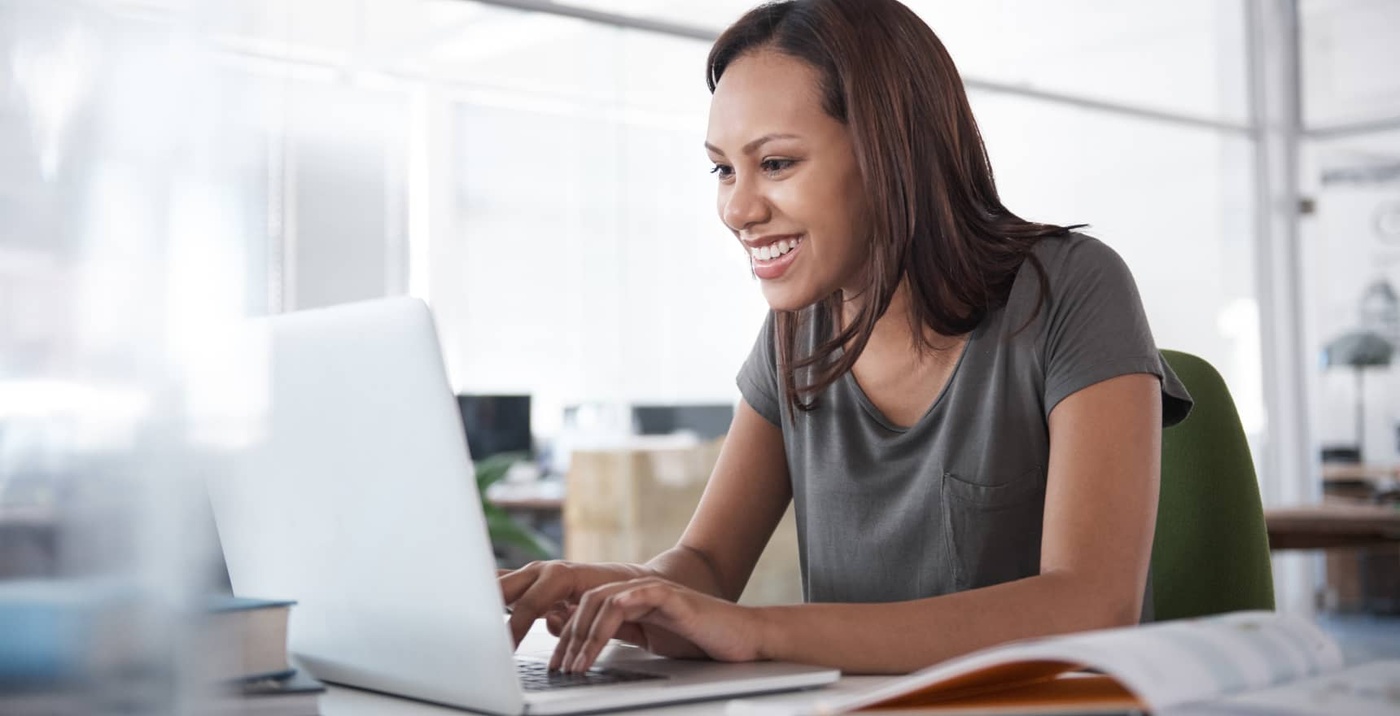 Smiling woman working on a laptop