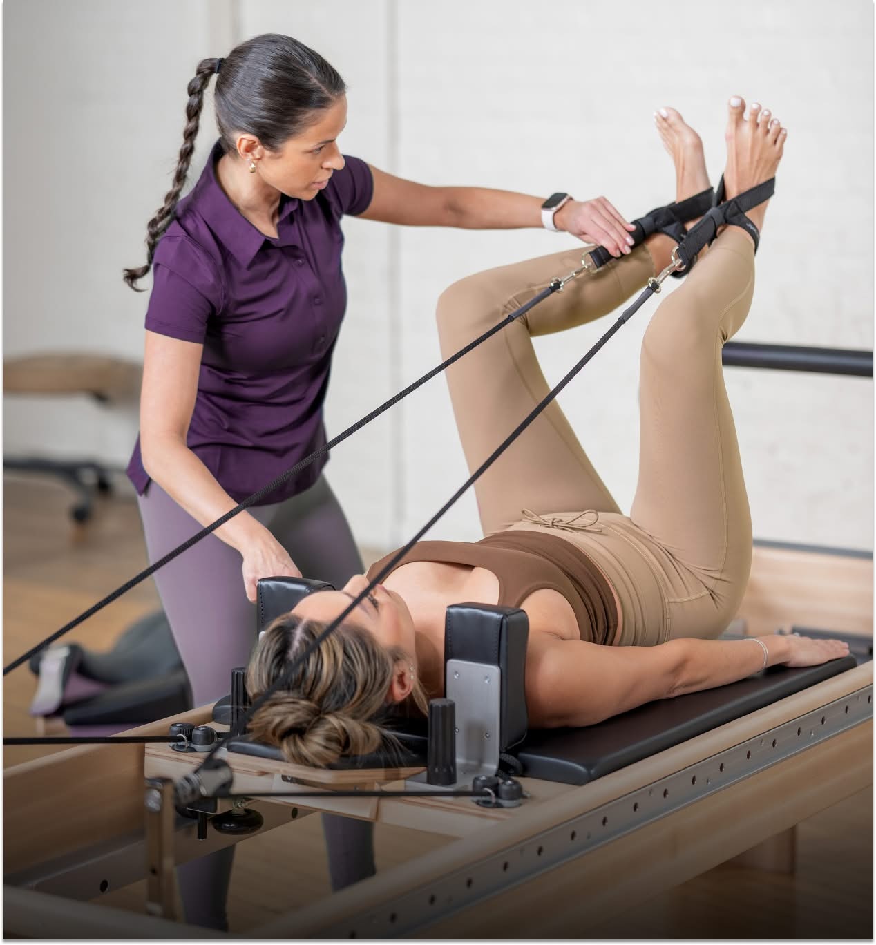 pt professional with student on reformer