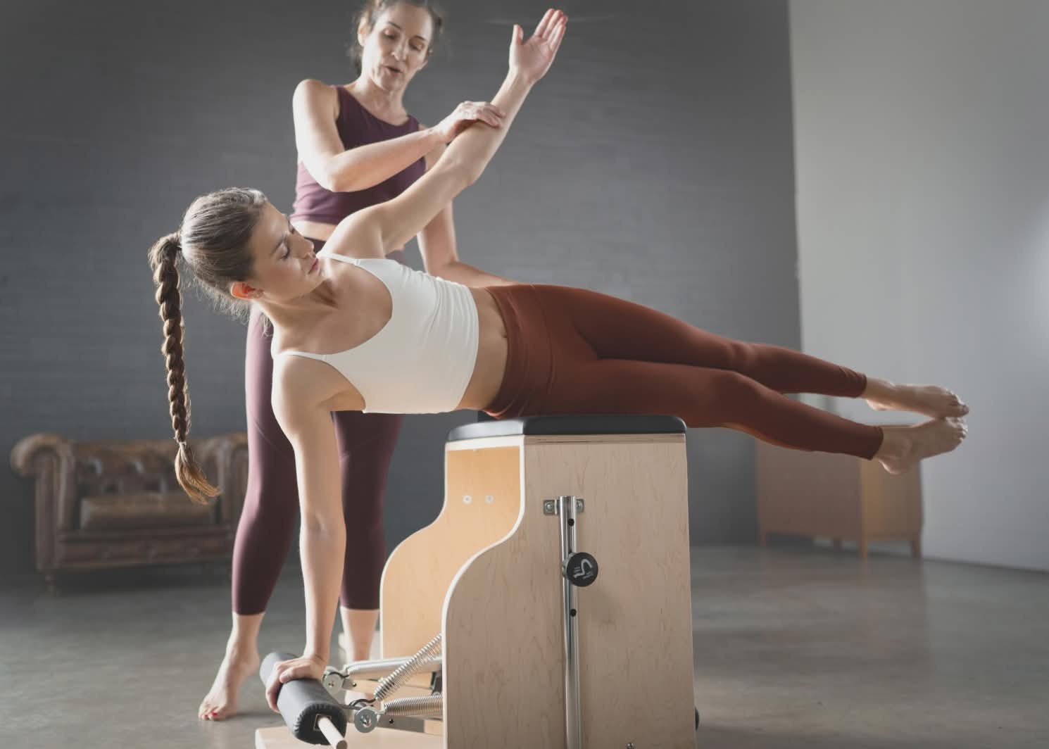 teacher with student on pilates chair