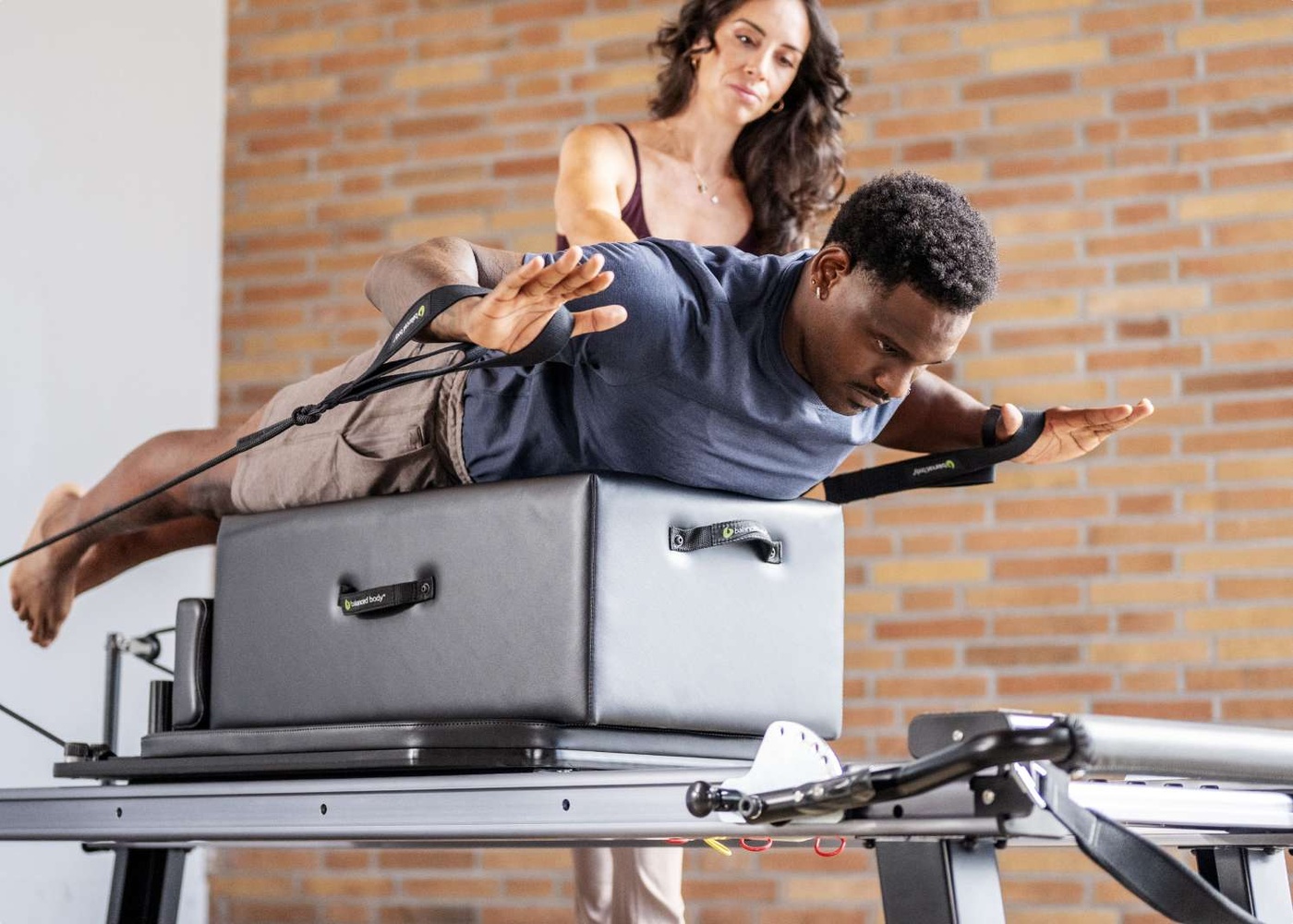 student on sitting box on nextgen reformer