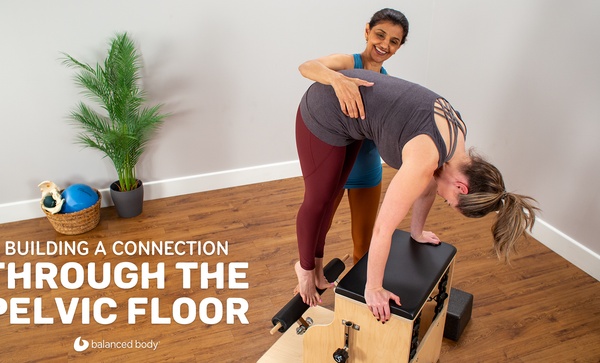 Building a connection through the pelvic floor woman instructor guiding student on combo chair