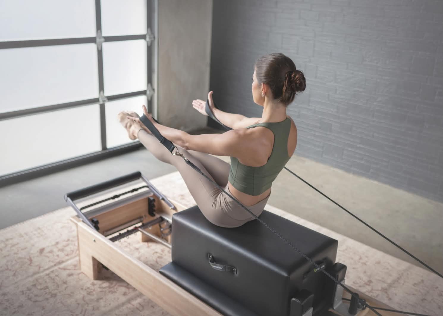 woman on studio reformer